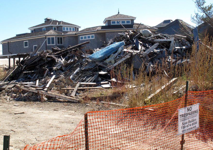 FILE - In this Oct. 15, 2013, file photo, a fence closes off the ruins of an oceanfront home in Mantoloking N.J. that was damaged by Superstorm Sandy. The House is pressing ahead with legislation to roll back a recently enacted overhaul of the federal flood insurance program after homeowners in flood-prone areas complained about sharp premium increases. (AP Photo/Wayne Parry, File)