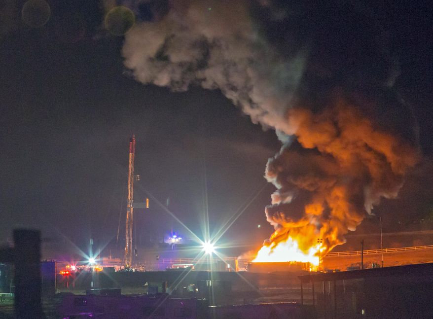 This photo provided by Nathan Hergert shows a fire burning at a oil and gas drilling site near Greeley, Colo., on Tuesday, March 4, 2014. Static electricity is being blamed for the massive explosion and fire at the oil and gas drilling site north of Greeley that injured two workers. (AP Photo/Nathan Hergert) MANDATORY CREDIT; MAGS OUT