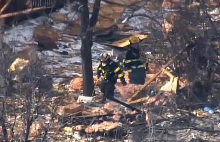 This aerial image taken from video and provided by Fox 29 Philadelphia, shows firefighters and rescue personnel working at the scene after an explosion at a townhouse complex Tuesday, March 4, 2014, in Ewing, N.J. (AP Photo/Fox 29 Philadelphia)