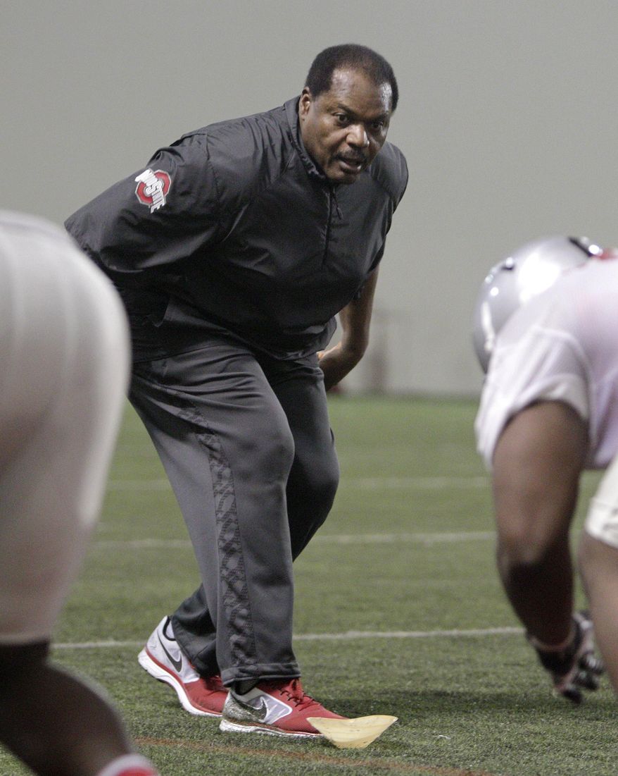Ohio State's new assistant head coach and defensive line coach Larry Johnson works with the defensive linemen during NCAA college football practice Tuesday, March 4, 2014, in Columbus, Ohio. (AP Photo/Jay LaPrete)
