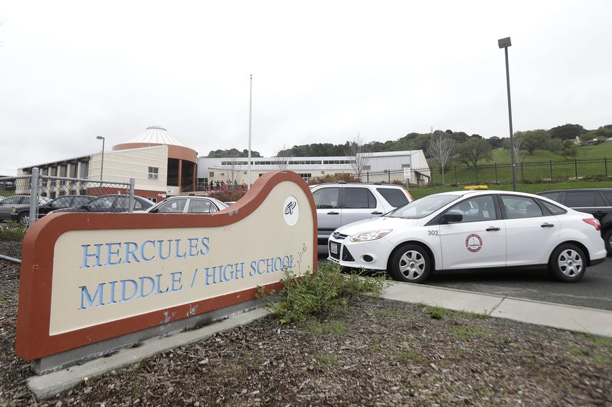 A sign for the Hercules Middle/High School campus is shown in Hercules, Calif., Tuesday, March 4, 2014. Police on Tuesday were investigating reports of a brutal assault of a transgender teen. The 15-year-old student told officers that he was leaving a boy's bathroom at the school on Monday when three teenage boys pushed him inside a handicapped stall and physically and sexually assaulted him, Hercules police Detective Connie Van Putten said. (AP Photo/Jeff Chiu)