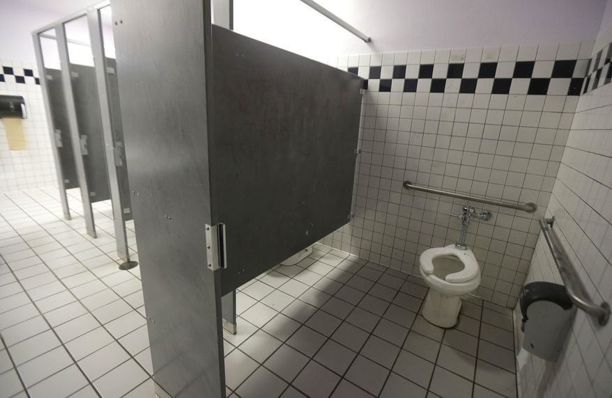A disabled toilet stall is shown in the boys bathroom at the Hercules Middle-High School campus in Hercules, Calif., Tuesday, March 4, 2014. (AP Photo/Jeff Chiu)