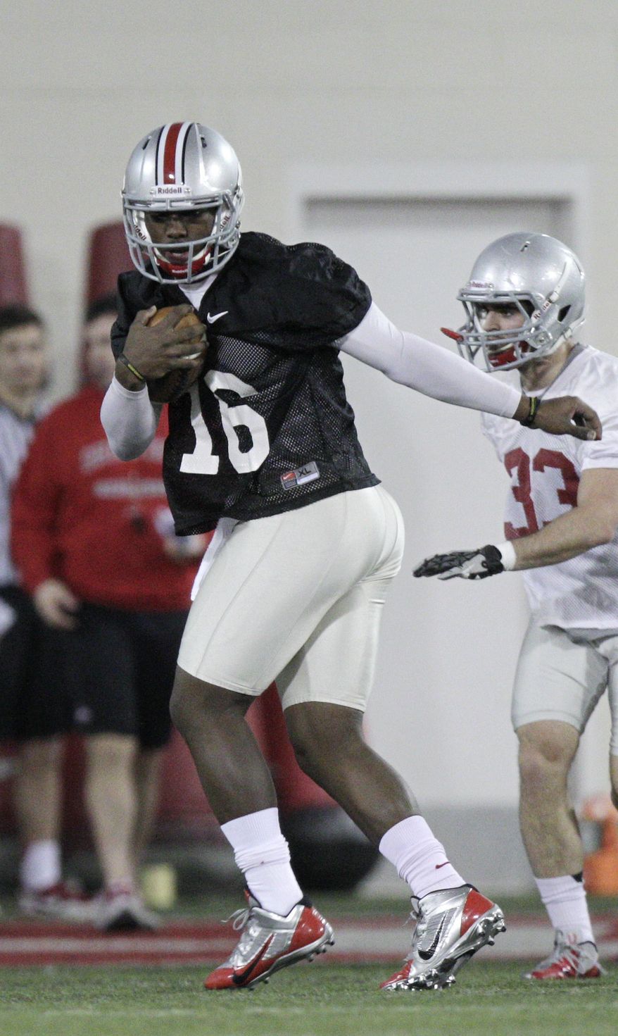 Ohio State quarterback JT Barrett warms up during their Spring NCAA college football practice Tuesday, March 4, 2014, in Columbus, Ohio. (AP Photo/Jay LaPrete)