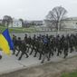 Ukrainian officers march at the Belbek air base, outside Sevastopol, Ukraine, on Tuesday, March 4, 2014. Russian troops, who had taken control over Belbek airbase, fired warning shots in the air as around 300 Ukrainian officers marched towards them to demand their jobs back. (AP Photo/Ivan Sekretarev)
