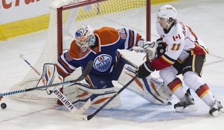 Calgary Flames&#39; Mikael Backlund (11) is stopped by Edmonton Oilers goalie Ilya Bryzgalov (80) during third period NHL hockey action in Edmonton, Alberta, on Saturday March 1, 2014.  (AP Photo/The Canadian Press, Jason Franson)