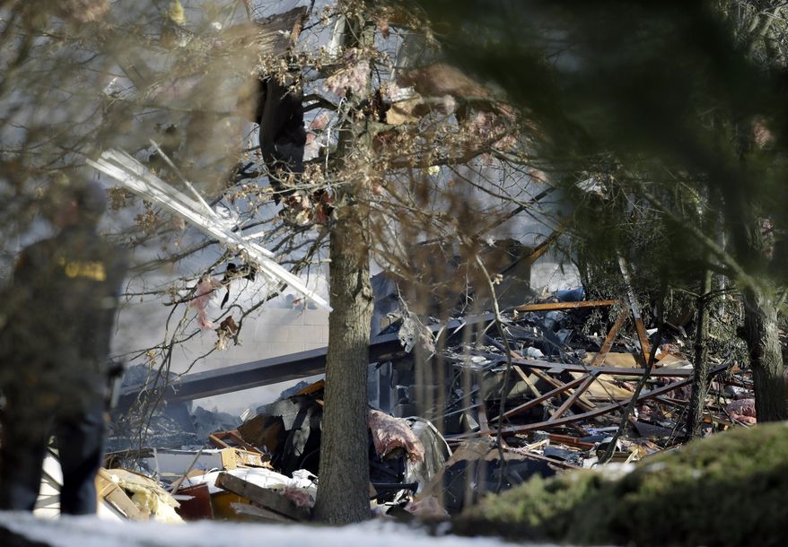 Debris is strewn about after an explosion at a townhouse complex Tuesday, March. 4, 2014, in Ewing, N.J. Authorities say just three of seven people hurt in the gas explosion will need to be admitted to a hospital, and a hospital official says none has life-threatening injuries. PSE&G crews were repairing a gas line damaged by a private contractor when the gas ignited at the suburban town house development. (AP Photo/Mel Evans)