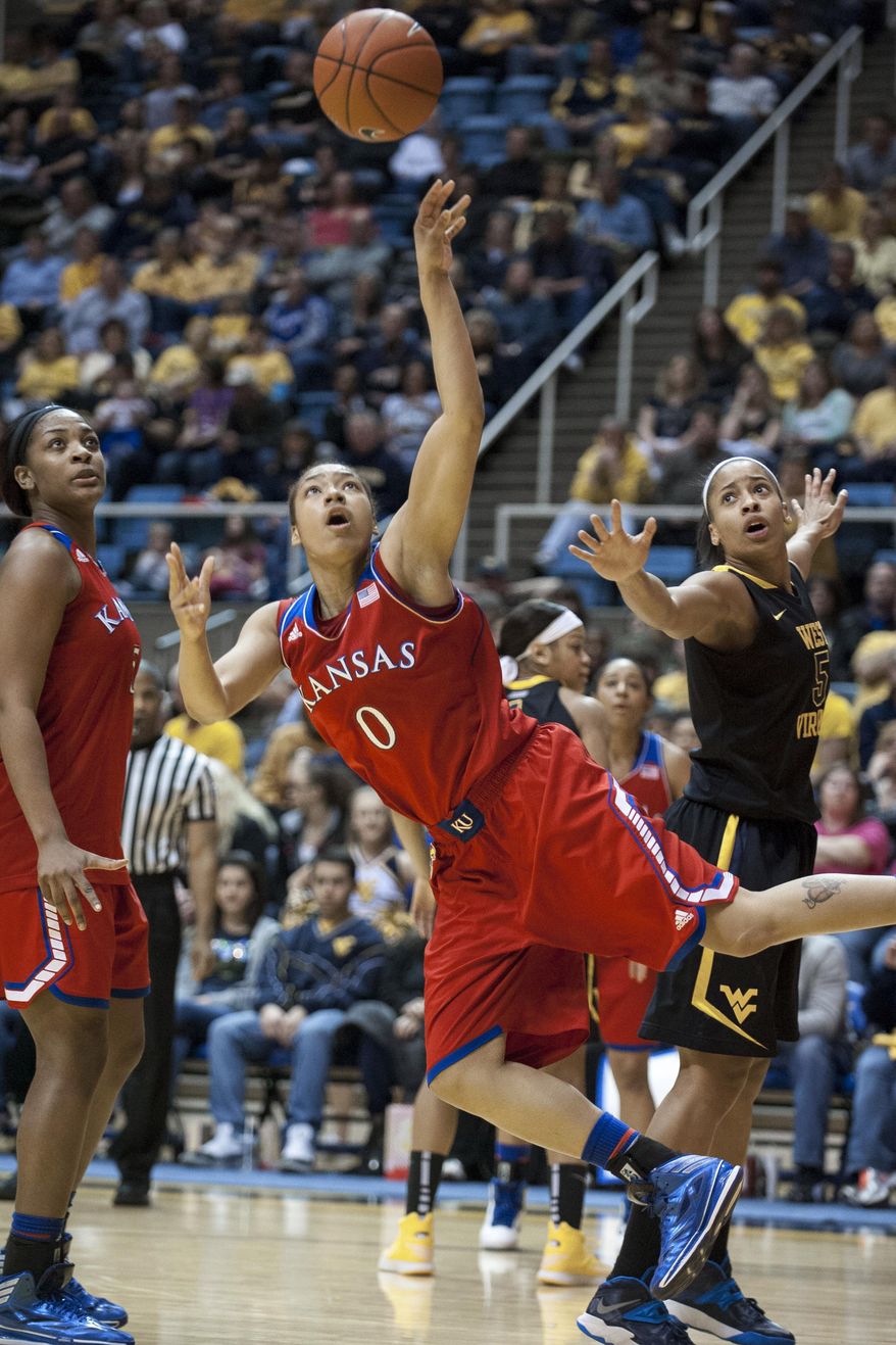 Kansas' Asia Boyd (0) drives to the basket during the first half of an NCAA college basketball game against West Virginia, Tuesday, March 4, 2014, in Morgantown, W.Va. (AP Photo/Andrew Ferguson)