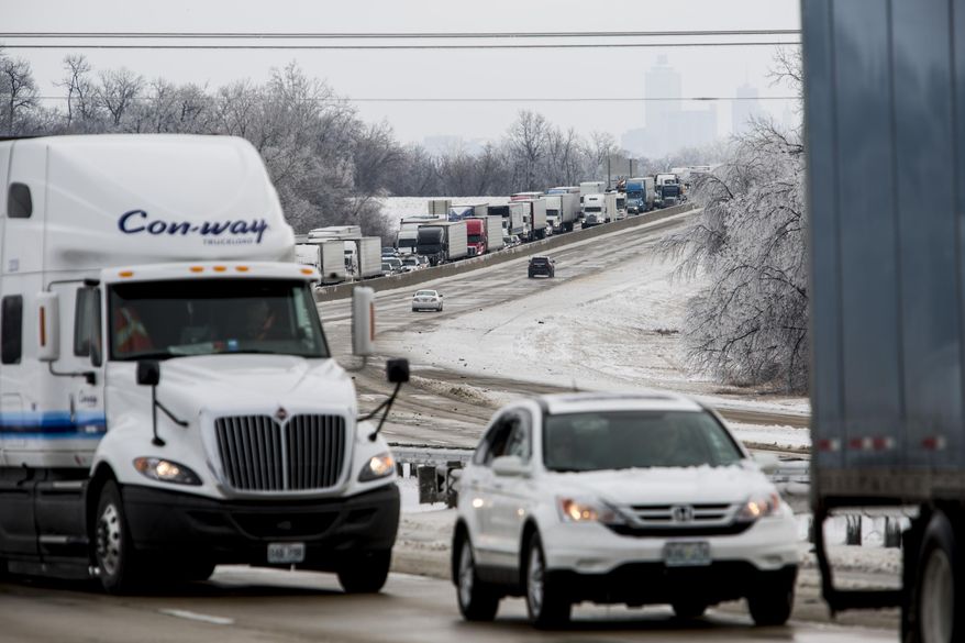 Traffic crawls along westbound Interstate 40 Tuesday morning, March 4, 2014, in West Memphis, Ark, after crossing over the Mississippi River from Memphis, Tenn. Some motorists on the highway in eastern Arkansas were stranded overnight due to lingering icy conditions from a weekend winter storm. An Arkansas highway department spokesman said Tuesday that traffic can't get moving consistently because of repeated accidents. (AP Photo/The Commercial Appeal, Brad Vest)