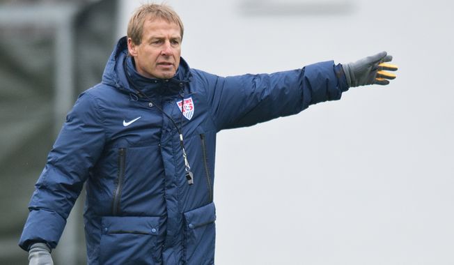 Juergen Klinsmann, coach of the US American national soccer team, leads a training session of his team  in Frankfurt Germany, Monday March 3, 2014. The US team will face Ukraine on Cyprus on Wednesday.   (AP Photo/dpa,Boris Roessler)
