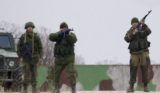 Russian soldiers fire warning shots at the Belbek air base, outside Sevastopol, Ukraine, on Tuesday, March 4, 2014. Russian troops, who had taken control over Belbek airbase, fired warning shots in the air as around 300 Ukrainian officers marched towards them to demand their jobs back. (AP Photo/Ivan Sekretarev)