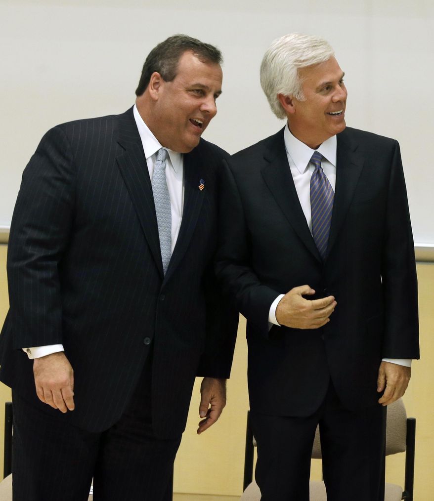 New Jersey Gov. Chris Christie, left, talks with George E. Norcross III, at a groundbreaking ceremony Wednesday, March 5, 2014, in Camden, N.J., for a new kind of school that Norcross' family foundation will help fund. Norcross, a powerful New Jersey Democrat complimented the governor at the groundbreaking ceremony. (AP Photo/Mel Evans)