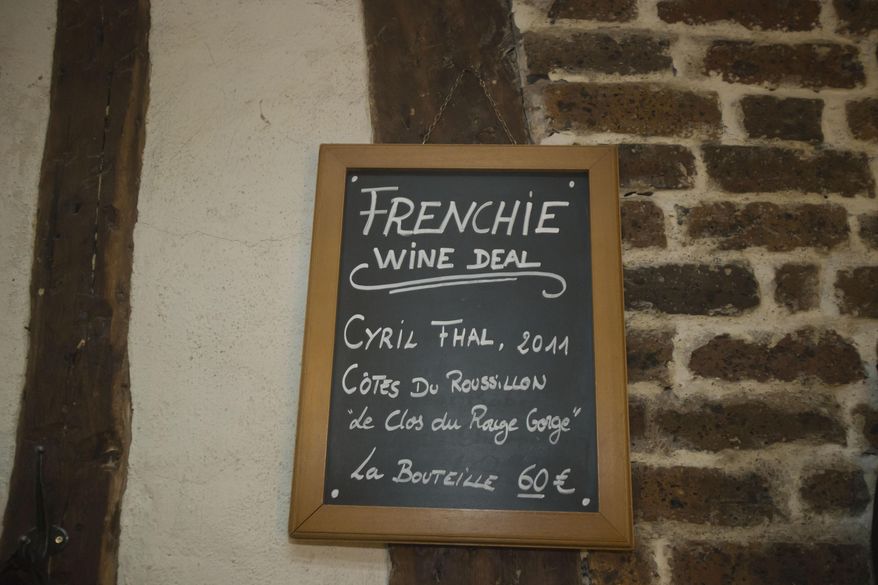 A board shows the day's wine deal at chef Greg Marchand's restaurant Frenchie in Paris on Thursday, Feb. 13, 2014. Frenchie, the restaurant he founded in 2009 after leaving New York’s Gramercy Tavern, has become a destination for as many diners as can snag a reservation. For the many who are shut out of the restaurant, he has a cookbook coming out in March. (AP Photo/Michel Euler)