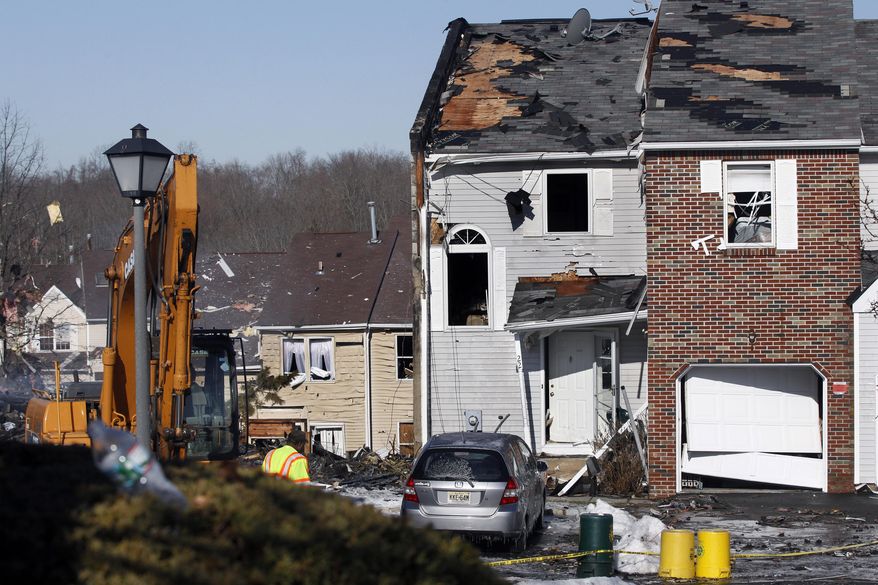 This Wednesday, March, 5, 2014 photo shows debris and damage from the previous day's explosion at a townhouse complex in Ewing, N.J. Investigators are looking to determine what triggered a natural gas leak and explosion that devastated the development, killing one woman and injuring seven workers. (AP Photo/Mel Evans)