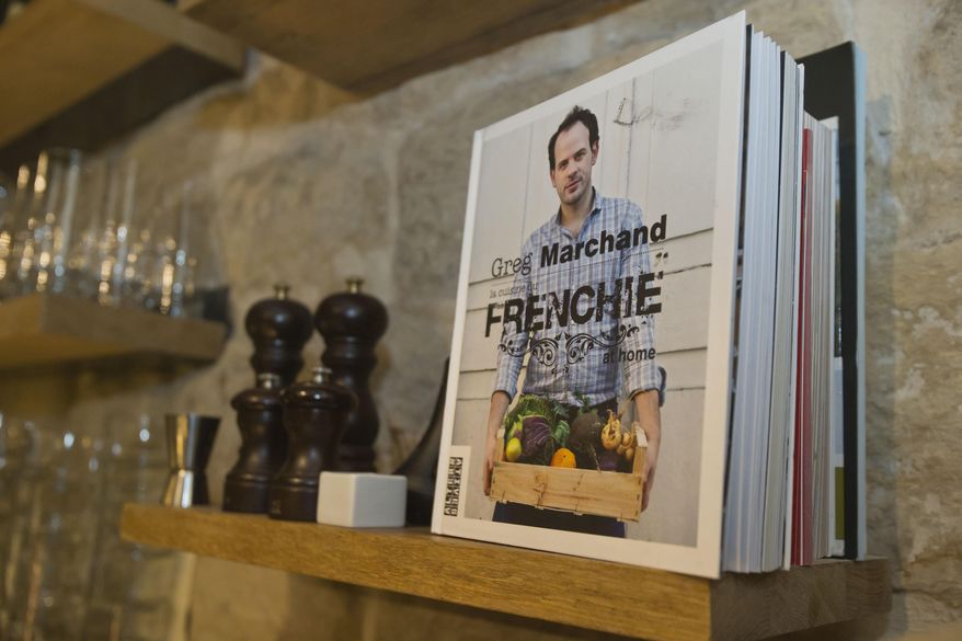 A cookbook by chef Greg Marchand is diplayed on a shelf at the Frenchie wine bar in Paris on Thursday, Feb. 13, 2014. Frenchie, the Marchand founded in 2009 after leaving New York’s Gramercy Tavern, has become a destination for as many diners as can snag a reservation. For the many who are shut out of the restaurant, he has a cookbook coming out in March. (AP Photo/Michel Euler)