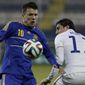 Yevhen Konoplianka, left, of Ukraine controls the ball with Alejandro Bedoya of U.S. during an international friendly match at Antonis Papadopoulos stadium in southern city of Larnaca, Cyprus, Wednesday, March 5, 2014.  The Ukrainians are facing the United States in a friendly on Wednesday in Cyprus, a match moved from Kharkiv to Larnaca for security reasons. (AP Photo/Petros Karadjias)