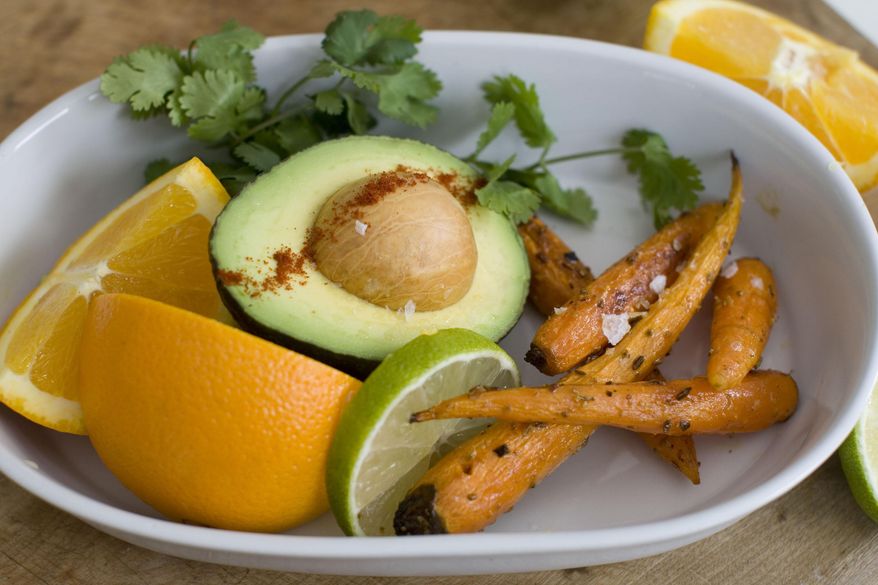 This Feb. 10, 2014 photo shows the ingredients for roasted carrot, orange and avacado salad in Concord, N.H. The recipe is adapted from Greg Marchand's cookbook, "Frenchie." (AP Photo/Matthew Mead)