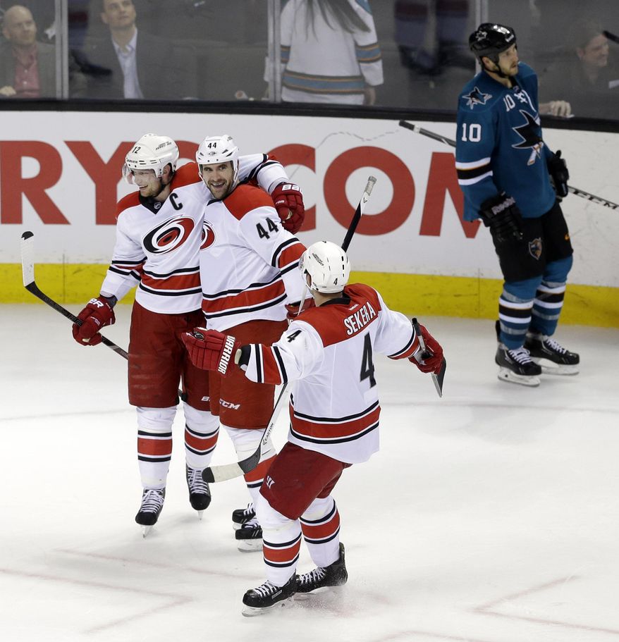 Carolina Hurricanes' Jay Harrison (44) celebrates his game-winning goal with teammates during overtime of an NHL hockey game on Tuesday, March 4, 2014, in San Jose, Calif. Carolina won 3-2. (AP Photo/Marcio Jose Sanchez)