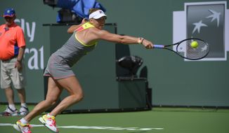 Vera Zvonareva, of Russia, returns a shot against Peng Shuai, of China, during a first round match at the BNP Paribas Open tennis tournament, Wednesday, March 5, 2014, in Indian Wells, Calif. (AP Photo/Mark J. Terrill)