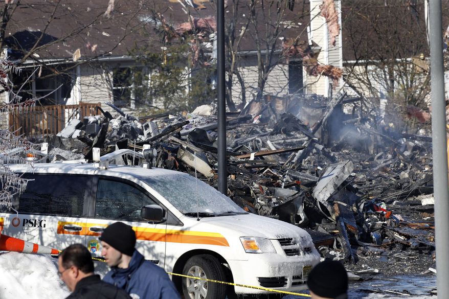 This Wednesday, March, 5, 2014 photo shows debris and damage from the previous day's explosion at a townhouse complex in Ewing, N.J. Investigators are looking to determine what triggered a natural gas leak and explosion that devastated the development, killing one woman and injuring seven workers. (AP Photo/Mel Evans)