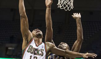 Milwaukee Bucks&#39; Ramon Sessions, left, shoots over Utah Jazz Alec Burks during the first half of an NBA basketball game Monday, March 3, 2014, in Milwaukee. (AP Photo/Tom Lynn)