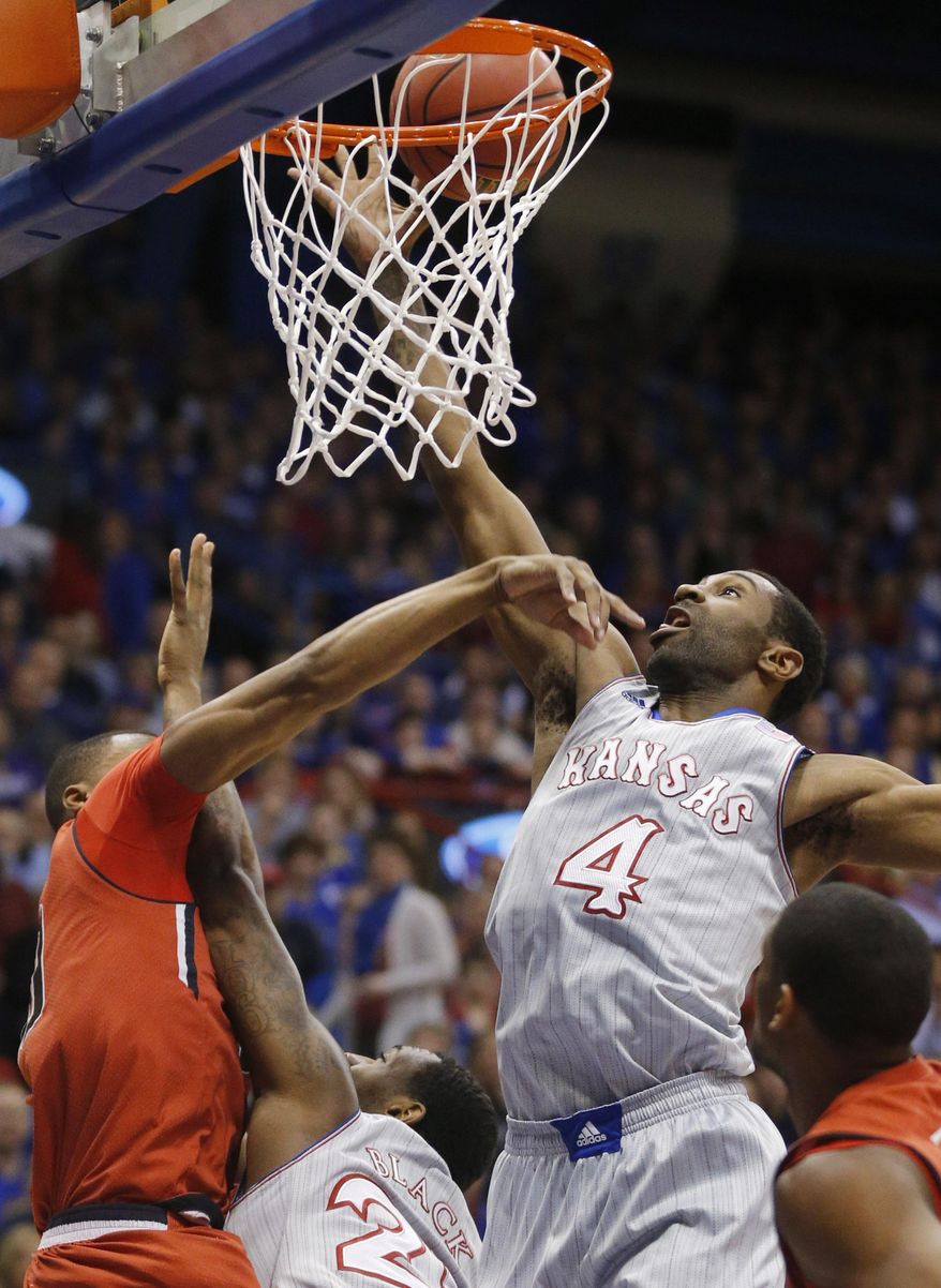 Kansas forward Justin Wesley (4) reaches for a rebound during the first half of an NCAA college basketball game against Texas Tech in Lawrence, Kan., Wednesday, March 5, 2014. (AP Photo/Orlin Wagner)