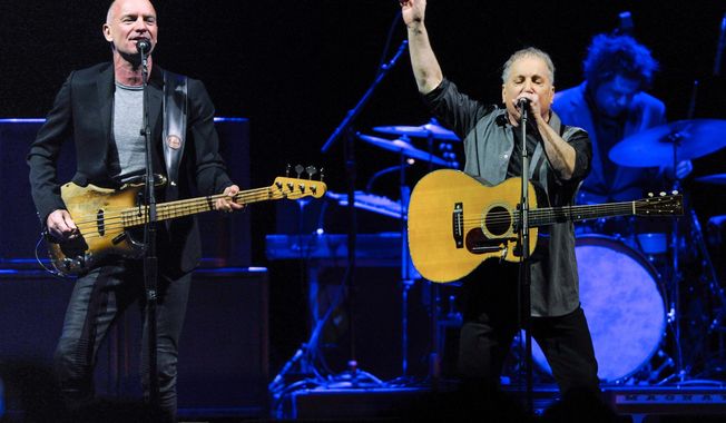 Musicians Sting, left, and Paul Simon perform together in concert at Madison Square Garden on Tuesday, March 4, 2014, in New York. (Photo by Evan Agostini/Invision/AP)