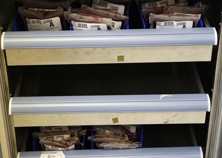 In this Tuesday, March 4, 2014 photo, shelves containing units blood are seen in storage at the Central Illinois Community Blood Center in Springfield, Ill. The blood center says they are running around 70 percent of where they should be after a cold winter is suspected of detracting donors. (AP Photo/The State Journal-Register, Justin L. Fowler)