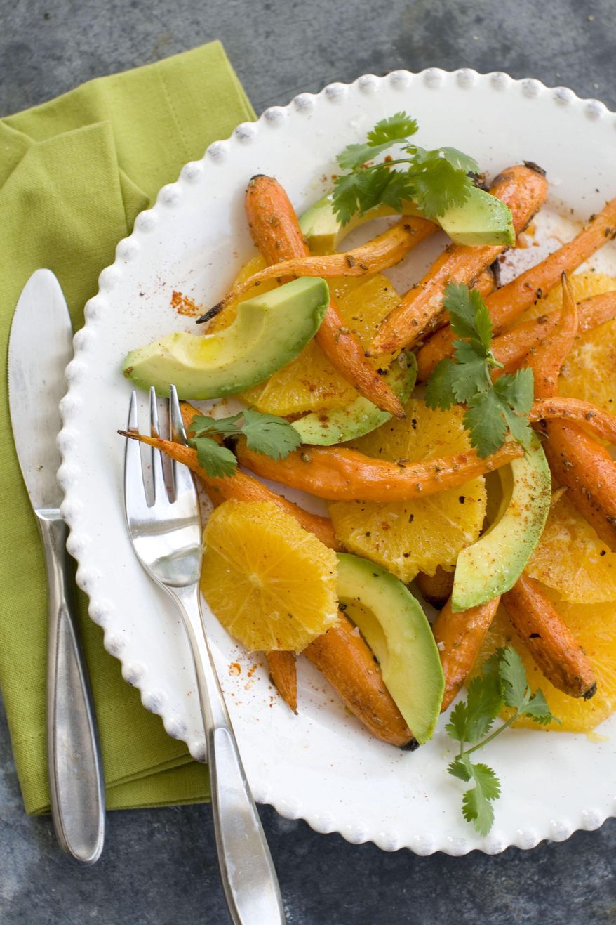 This Feb. 10, 2014 photo shows roasted carrot, orange and avacado salad in Concord, N.H. The recipe is adapted from Greg Marchand's cookbook, "Frenchie." (AP Photo/Matthew Mead)