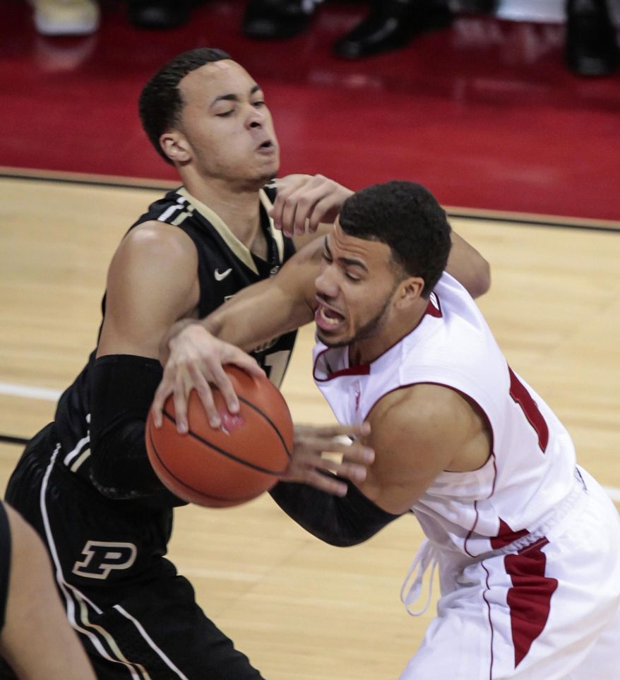 Purdue's Kendall Stephens, left, and Wisconsin's Traevon Jackson battle for the ball during the first half of an NCAA college basketball game Wednesday, March 5, 2014, in Madison, Wis. (AP Photo/Andy Manis)