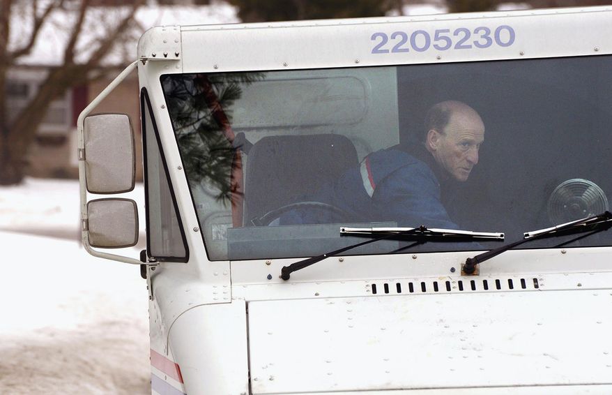 **FILE** U.S. Postal Service letter carrier Gary Keist prepares to deliver mail on his route in Normal, Ill., on Feb. 20, 2014. (Associated Press/The Pantagraph, Steve Smedley)
