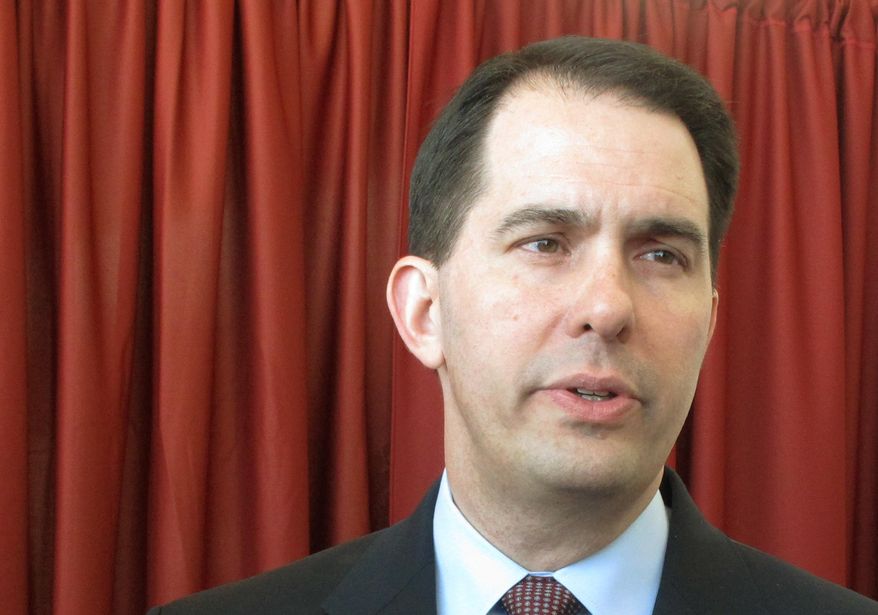 Gov. Scott Walker talks about the release of the first television ad run against him by Democratic challenger Mary Burke on Wednesday, March 5, 2014, in Madison, Wis. The ad, released by Burke’s campaign online Wednesday, comes eight months before the November election and signals that the race is heating up. (AP Photo/Scott Bauer)