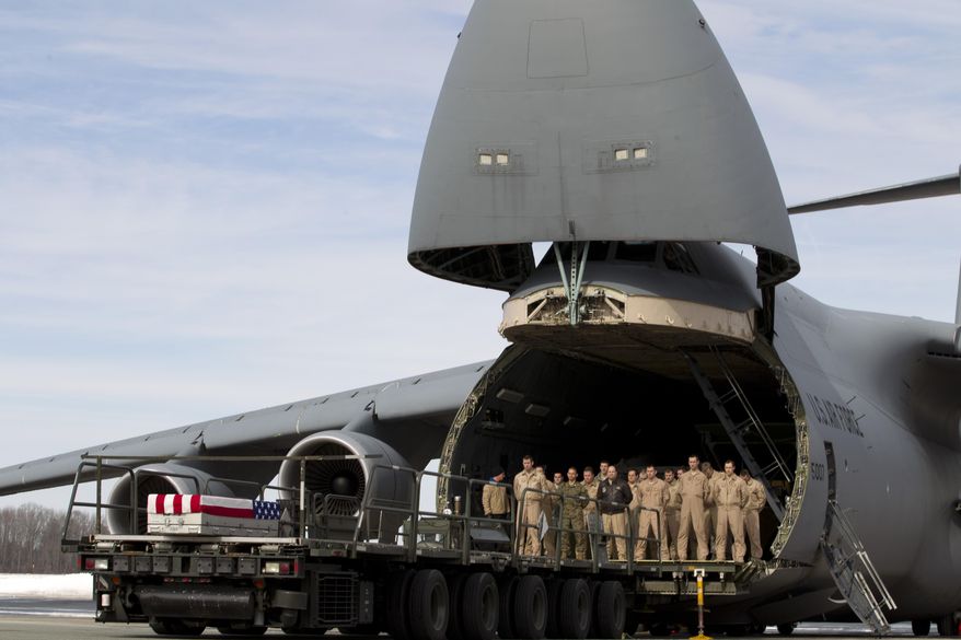 The transfer case containing the remains of Marine Lance Cpl. Caleb L. Erickson of Waseca, Minn., sits at the end of the loader ramp, upon arrival at Dover Air Force Base, Del. on Tuesday, March 4, 2014. The Department of Defense announced the death of Erickson who was supporting Operation Enduring Freedom in Afghanistan. ( AP Photo/Jose Luis Magana)