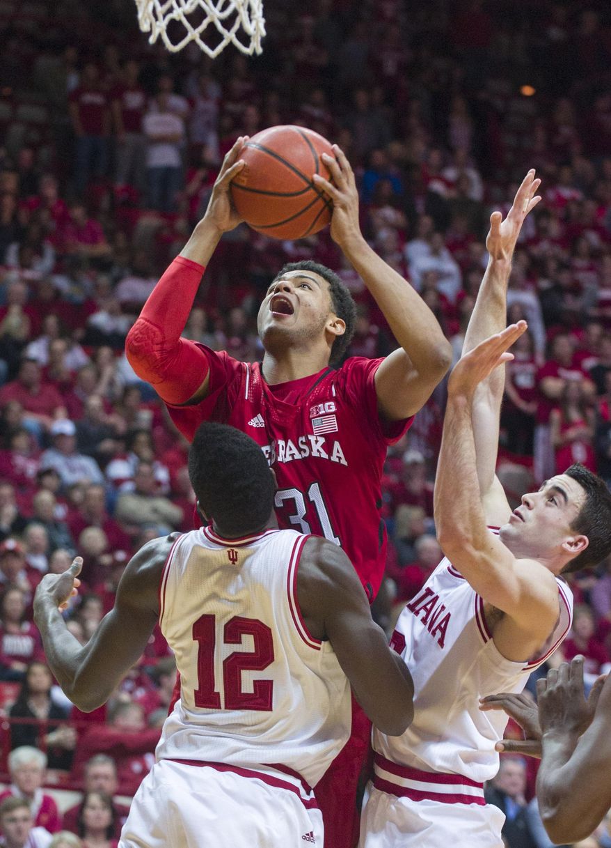 Nebraska’s Shavon Shields (31) goes up for a shot as Indiana's Hanner Mosquera-Perea (12) and Will Sheehey try to block his efforts in the first half of an NCAA college basketball game, Wednesday, March 5, 2014, in Bloomington, Ind. (AP Photo/Doug McSchooler)