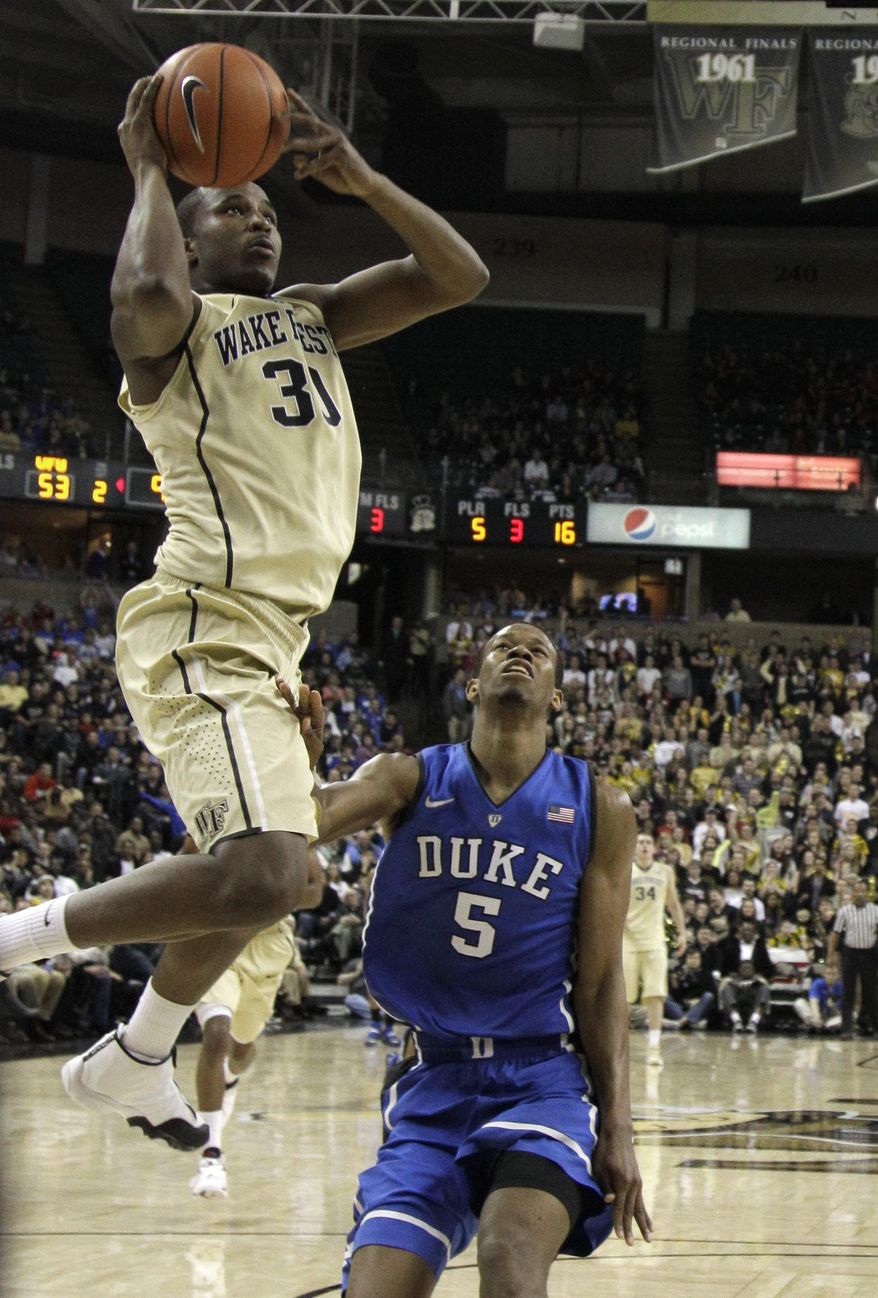 Wake Forest's Andre Washington (31) drives past Duke's Rodney Hood (5) during the second half of an NCAA college basketball game in Winston-Salem, N.C., Wednesday, March 5, 2014. Wake Forest won 82-72. (AP Photo/Chuck Burton)