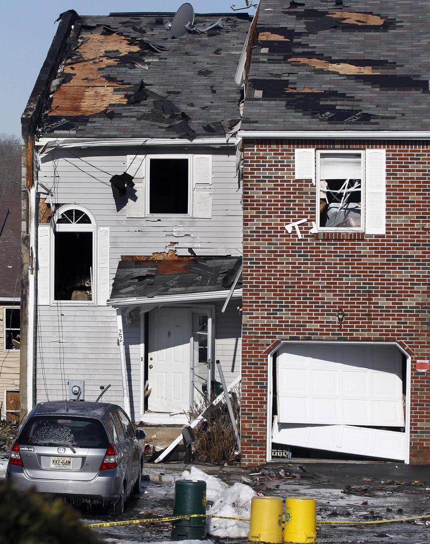This Wednesday, March, 5, 2014 photo shows debris and damage from the previous day's explosion at a townhouse complex in Ewing, N.J. Investigators are looking to determine what triggered a natural gas leak and explosion that devastated the development, killing one woman and injuring seven workers. (AP Photo/Mel Evans)