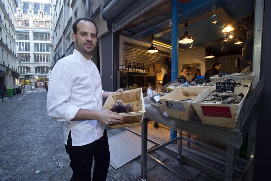 Chef Greg Marchand buys seafood for his restaurant Frenchie in Paris on Thursday, Feb. 13, 2014. Marchand’s meandering path - hotel restaurants in London and Hong Kong, a beachside bar in Spain, Jamie Oliver’s kitchen, New York’s Gramercy Tavern - put him at the crest of bistronomie, the French movement combining highbrow gastronomy and the lowly corner bistro. He returned to France in 2009, just coming into his 30s and into his own as a chef. (AP Photo/Michel Euler)