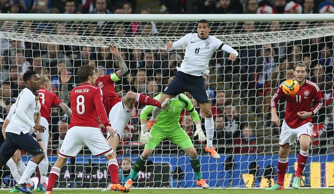 England&#x27;s Chris Smalling, leaps but fails to connect with the ball during the international friendly soccer match between England and Denmark at Wembley stadium in London Wednesday, March  5,  2014. (AP Photo/Alastair Grant)