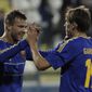 Andriy Yarmolenko, left, with his teammate Denys Garmash of Ukraine celebrate his goal against U.S. during an international friendly match at Antonis Papadopoulos stadium in southern city of Larnaca, Cyprus, Wednesday, March 5, 2014. The Ukrainians are facing the United States in a friendly in Cyprus, a match moved from Kharkiv, Ukraine, to Larnaca for security reasons. (AP Photo/Petros Karadjias)