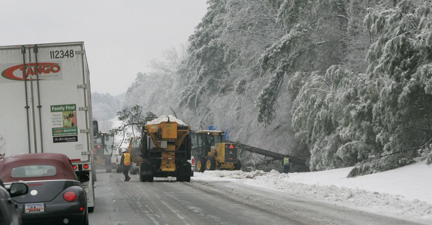 FILE - In this Feb. 13, 2014 file photo, traffic stopps on Interstate 26 near Chapin, S.C., as crews remove a fallen tree following the worst winter storm in South Carolina in a decade. Gov. Nikki Haley on Tuesday, March 4, 2014, asked President Obama to declare a disaster area in 21 of South Carolina's 46 counties as a result of the storm. (AP Photo/Mary Ann Chastain, File)
