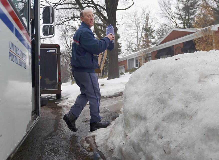 ADVANCE FOR USE SUNDAY, MARCH 9 AND THEREAFTER - In this Feb. 20, 2014 photo, U.S. Postal Service letter carrier Gary Keist prepares to make a delivery to a home in Normal, Ill. Keist, 56, began as a letter carrier in 1978 and said this winter is the worst he's ever worked because of the consistent pattern of snowfalls followed by bitterly cold temperatures with little or no break. (AP Photo/The Pantagraph, Steve Smedley)