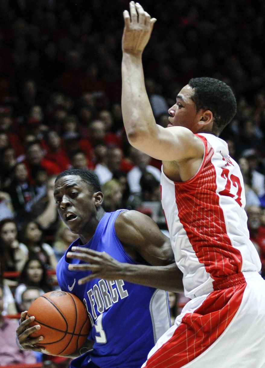 Air Force's Justin Hammonds (3) drives to the hoop guarded by New Mexico's Merv Lindsay (22) during the first half of an NCAA college basketball game at The Pit in Albuquerque, N.M., Wednesday, March 5, 2014. (AP Photo/Juan Antonio Labreche)