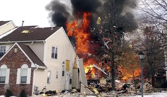In this image provided by Josh Forst, flames and smoke shoot up after an explosion at a townhouse complex Tuesday, March 4, 2014, in Ewing, N.J. A gas line damaged by a contractor exploded &amp;quot;like a bomb&amp;quot; while utility crews worked to repair it Tuesday at the complex, injuring at least seven people while several homes were destroyed or damaged.  (AP Photo/Josh Forst)