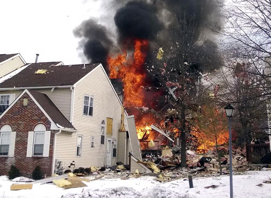 In this image provided by Josh Forst, flames and smoke shoot up after an explosion at a townhouse complex Tuesday, March 4, 2014, in Ewing, N.J. A gas line damaged by a contractor exploded "like a bomb" while utility crews worked to repair it Tuesday at the complex, injuring at least seven people while several homes were destroyed or damaged. (AP Photo/Josh Forst)