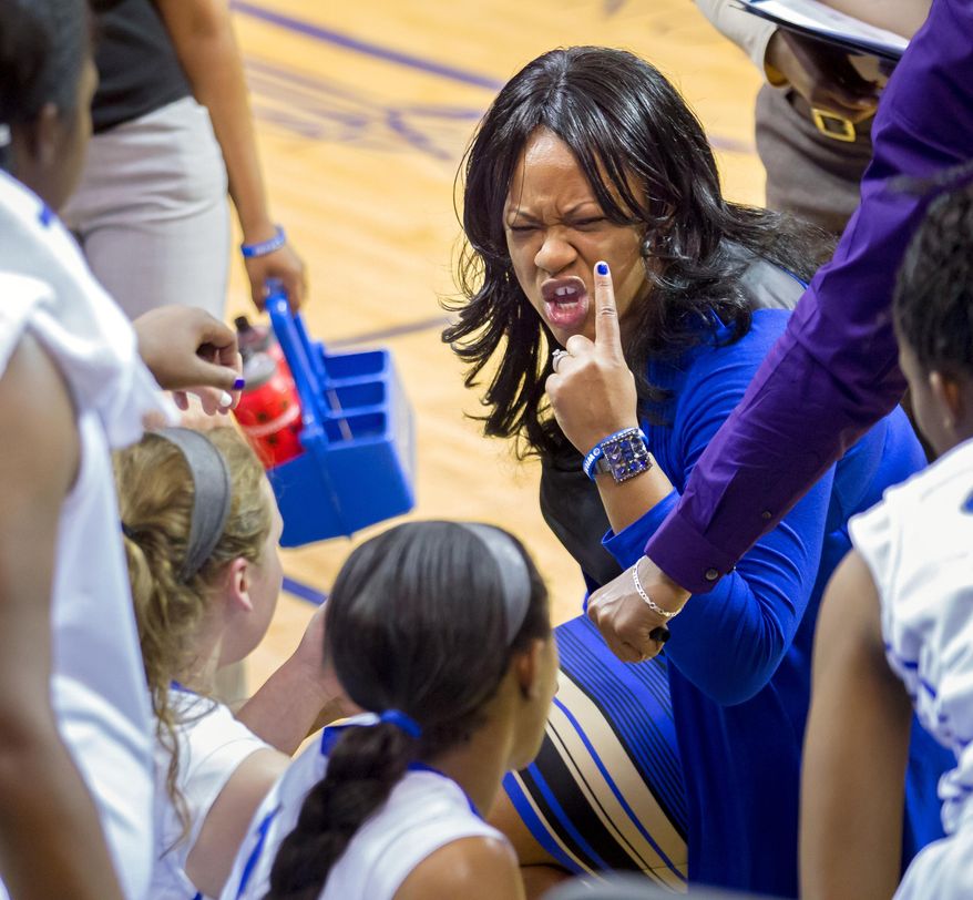 This Jan. 16, 2014 photo shows New Orleans women's basketball coach Keeshawn Davenport talking to her players during an NCAA college basketball game against Lamar, in New Orleans. Despite her team's 0-27 record, Davenport says she loves coming to work and does not fear for her job. (AP Photo/The New Orleans Advocate, Scott Threlkeld) (AP Photo/The Advocate, ) MAGS OUT; INTERNET OUT; NO SALES; TV OUT; NO FORNS; LOUISIANA BUSINESS INC. OUT (INCLUDING GREATER BATON ROUGE BUSINESS REPORT, 225, 10/12, INREGISTER, LBI CUSTOM); MANDATORY CREDIT