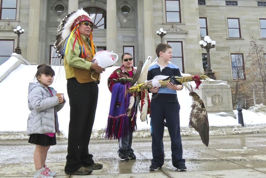James St. Goddard, spiritual leader of the Blackfeet Confederacy, speaks out against the hunting of pregnant bison by other tribes on the steps of the Montana state capitol building on Tuesday, March 4, 2014. (AP Photo/The Independent Record, Thom Bridge)