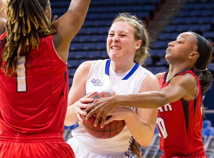 In this Jan. 16, 2014 photo, New Orleans women's NCAA college basketball player Octavia Wilson (21), center, gets fouled going up for a shot against Lamar'a Gia Ayers (1) and JaMeisha Edwards (20) during the second half of a game in New Orleans.Despite her team's 0-27 record, University of New Orleans women's basketball coach Keeshawn Davenport says she loves coming to work and does not fear for her job. (AP Photo/The New Orleans Advocate, Scott Threlkeld) (AP Photo/The Advocate, Scott Threlkeld) MAGS OUT; INTERNET OUT; NO SALES; TV OUT; NO FORNS; LOUISIANA BUSINESS INC. OUT (INCLUDING GREATER BATON ROUGE BUSINESS REPORT, 225, 10/12, INREGISTER, LBI CUSTOM); MANDATORY CREDIT