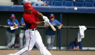 Washington Nationals&#39; Ian Desmond hits a solo home run in the third inning of a spring exhibition baseball game against the New York Mets, Wednesday, March 5, 2014, in Viera, Fla. (AP Photo/Alex Brandon)