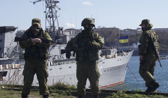 Russian soldiers guard a peer where two Ukrainian naval vessels are moored, in Sevastopol, Ukraine, on Wednesday, March 5, 2014. Ukraine&#x27;s new prime minister said Wednesday that embattled Crimea must remain part of Ukraine, but may be granted more local powers. Since last weekend, Russian troops have taken control of much of the peninsula in the Black Sea, where Russian speakers are in the majority. (AP Photo/Ivan Sekretarev)