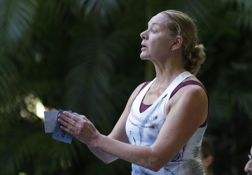 In this Saturday, Feb. 1, 2014 photo, Karen Peterson, artistic director of Karen Peterson and Dancers, rubs pieces of sandpaper together during a rehearsal of a piece titled "Grit" in Pinecrest, Fla. The Miami-based company uses dancers who are disabled to enhance their performances. Peterson, who started the company in 1990 out of a desire to to expand herself as a choreographer, refers to the dance style as "inclusive dance." (AP Photo/Lynne Sladky)