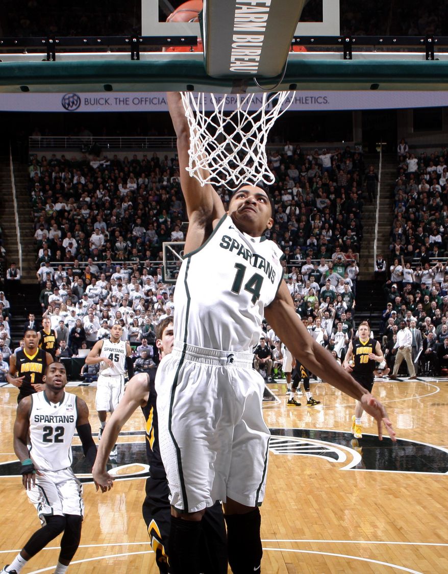 Michigan State's Gary Harris (14) goes up for a dunk against Iowa during the first half of an NCAA college basketball game, Thursday, March 6, 2014, in East Lansing, Mich. (AP Photo/Al Goldis)